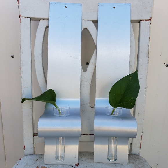 Metal wall sconces with glass vases